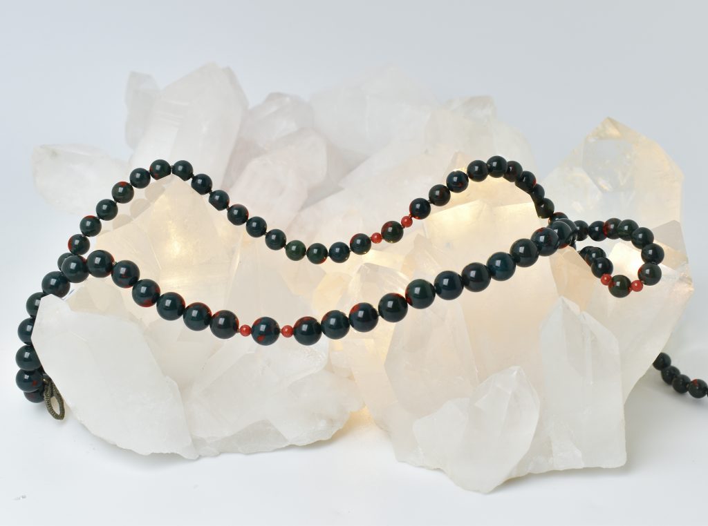 Bloodstone & Red Coral gemstone necklace on crystal
