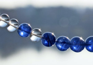 closeup of blue sapphire and white beryl gemstones