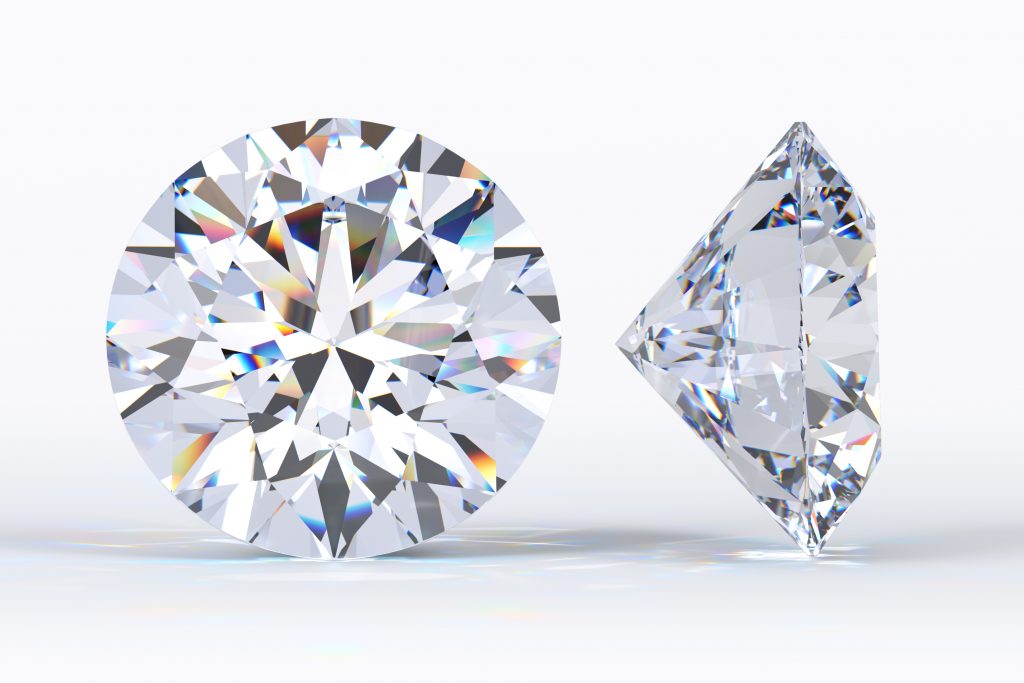 Two big round brilliant cut diamonds standing on white background