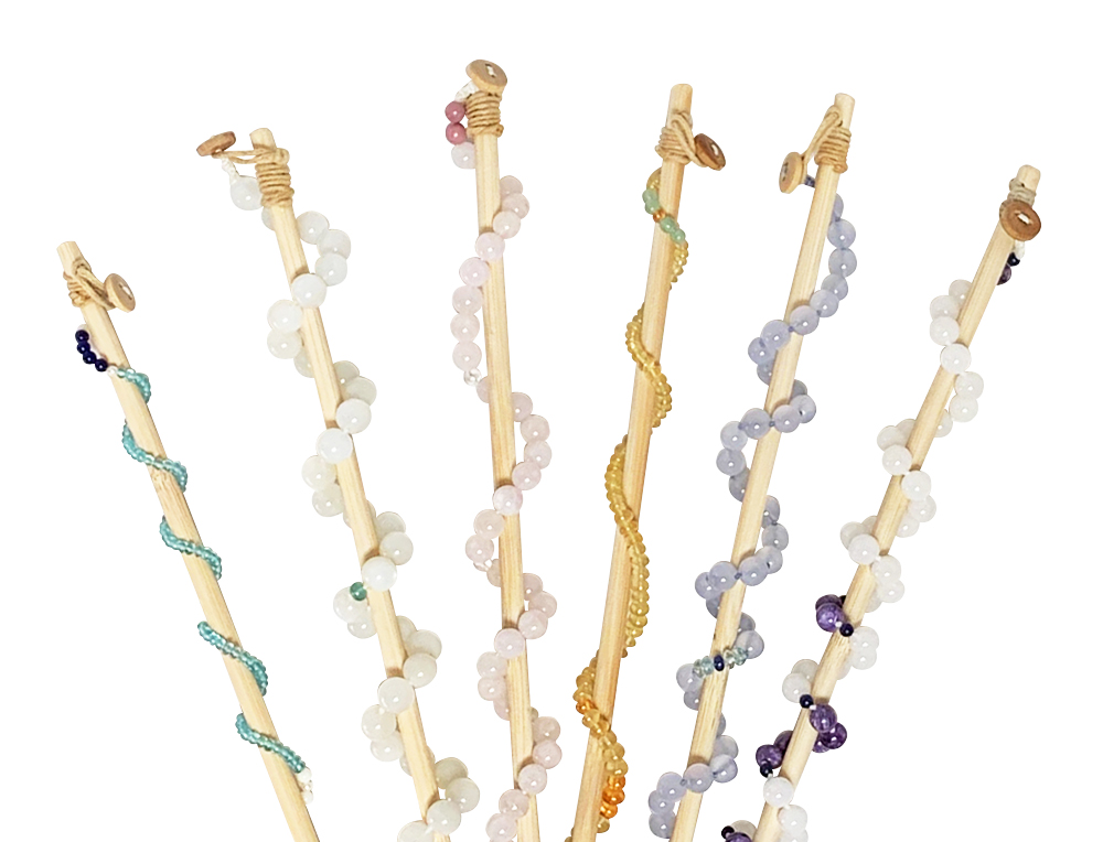 six therapy wands with a gemstone necklace wrapped around each one