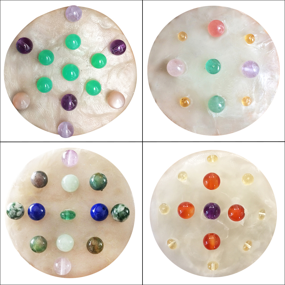 Four gemstone mandalas with different designs