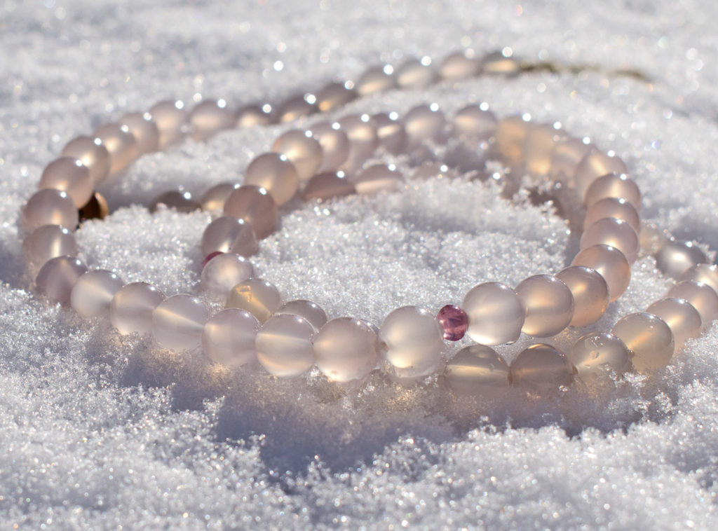 Gemstone necklace with Pink Chalcedony and Pink Spinel beads on snow