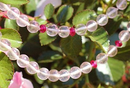 Rose Quartz & Red Spinel gemstone necklace outside in nature