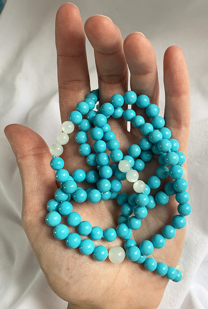 Turquoise & Moonstone gemstones in hand