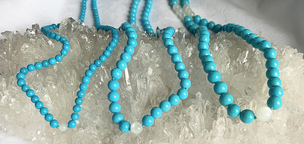 Turquoise & Moonstone necklaces on crystal cluster