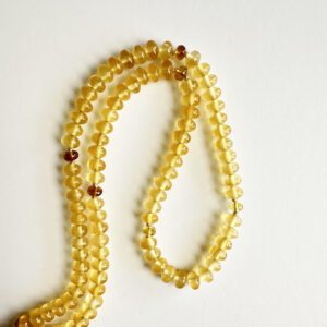 Yellow Fluorite gemstone necklace with golden yellow beads on white background