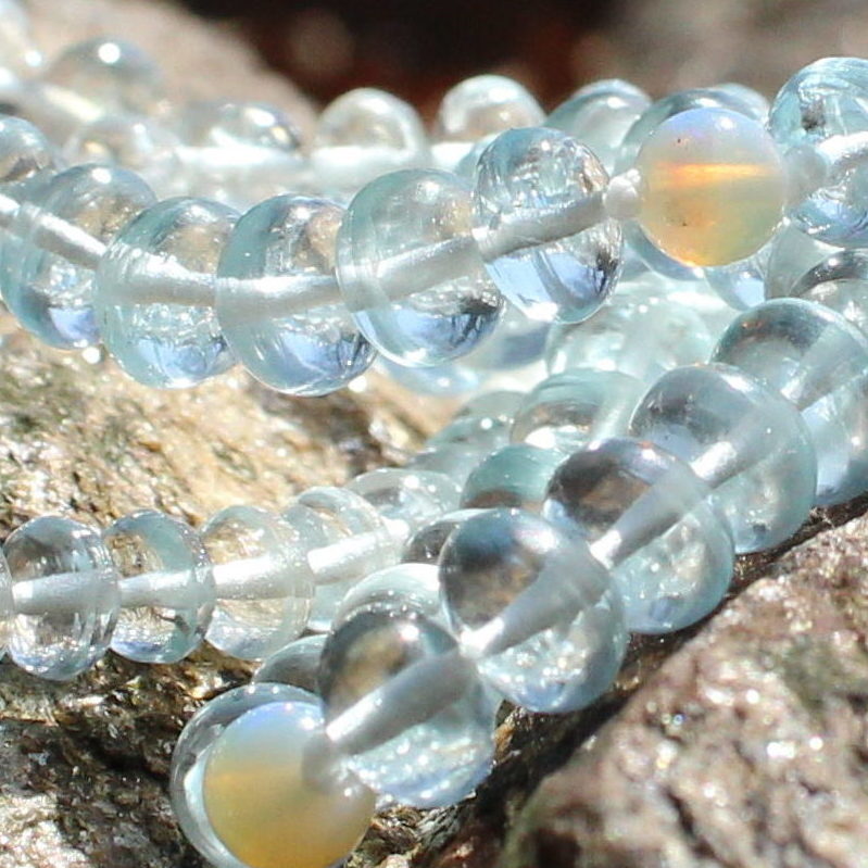 Blue Topaz gemstone rondels close up on rock