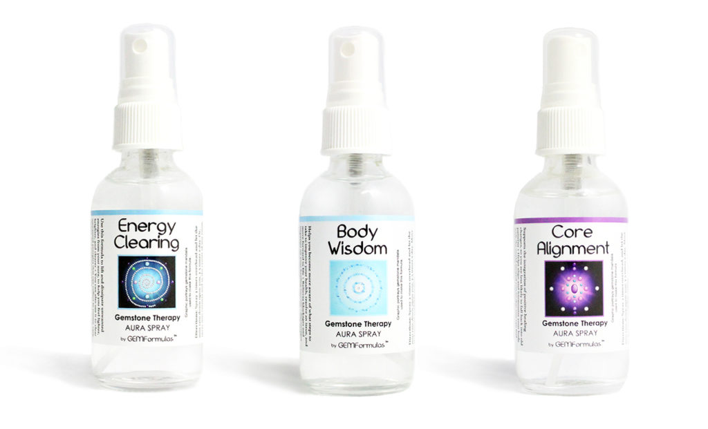 closeup photo of three bottles of gemstone aura sprays