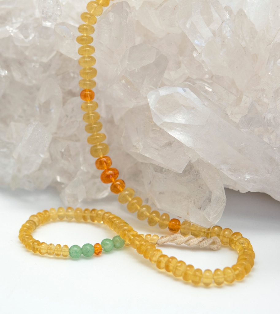 Golden Beryl gemstone necklace on crystal