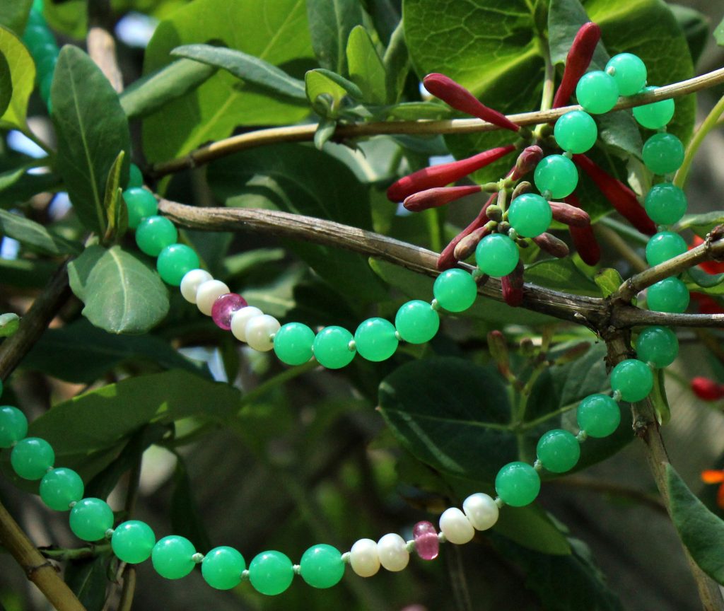Green chrysoprase gemstone necklace on plant