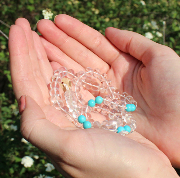 cupped hands holding White Beryl and Turquoise necklace